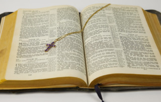 Open Bible with cross