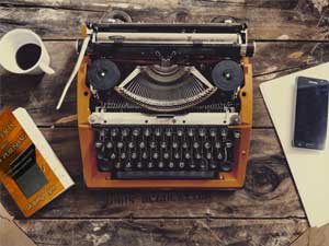 Simple Facts About Self-Publishing by Jacquelyn Lynn next to a typewriter