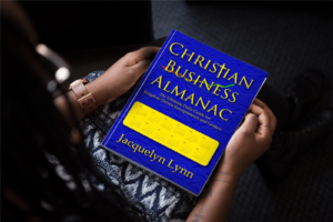 Woman holding Christian Business Almanac in her lap
